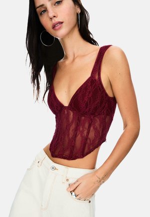Burgundy lace bodysuit with a deep V-neck and thin straps. Sheer texture with floral patterns, fitted shape, and side cutouts.