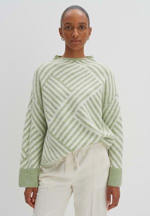 Light green and white striped oversized sweater with a crew neckline and ribbed cuffs, featuring a geometric pattern on soft texture.