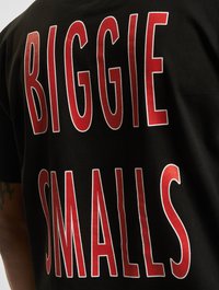 Black cotton t-shirt featuring large red print text: "BIGGIE SMALLS." Text is bold, with a slightly distressed appearance.