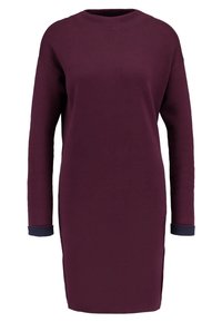 Mauvefarbenes langärmliges Kleid aus weich fallendem Stoff, mit Rundhalsausschnitt, seitlichen Schlitzen und marineblauen Bündchen. Gerade, lockere Passform mit minimaler Detailgestaltung.