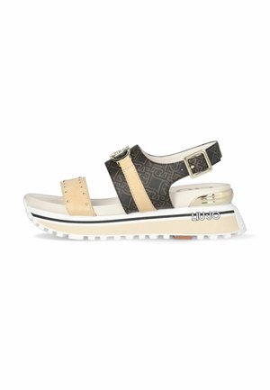 Sandali platform con design bicolore in beige e nero, motivo geometrico, fibbia regolabile e suola testurizzata con logo del marchio.