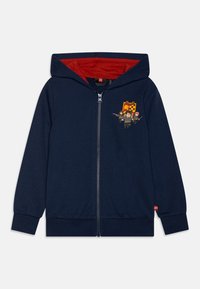 Naktiniai mėlyni zip-up džemperiai pagaminti iš minkštos medžiagos, su raudona vidine pamušalu ir LEGO personažų grafika kairėje krūtinės pusėje.