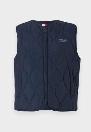 Námorně modrá prošívaná vesta s celopřezkou, kulatým výstřihem a s embosovaným logem. Design zahrnuje vlnité švy a boční kapsy.