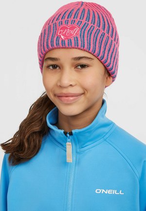 Pink and blue striped knit beanie featuring a heart logo; worn with a light blue jacket with a zip closure and logo.
