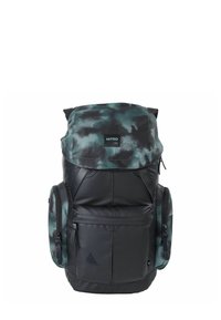 Backpack made of black and green camo fabric, featuring a top flap, zippered compartments, and side pockets. Durable and padded design.
