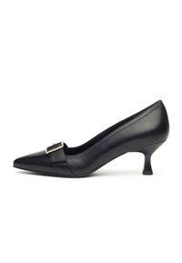 Black leather pump with a pointed toe, low heel, and a metallic buckle accent. Smooth texture and seamless design.