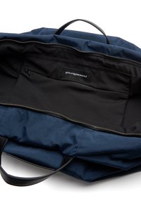 Borsa a spalla blu navy con superficie liscia, chiusura con zip, esterno in tessuto e fodera interna nera; dotata di etichetta e tasca interna.