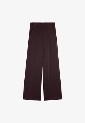 Ciemnobrązowe spodnie szerokie z elastycznym paskiem i bocznymi kieszeniami, ułożone na białym tle.