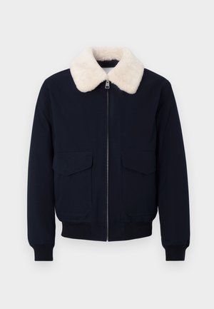 Marineblauwe bomberjas met een crème nepschapenvachtkraag; voorzien van een ritssluiting en twee voorzakken; geribbelde manchetten en zoom.