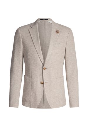 Blazer beige texturé avec revers crantés, deux poches avant et un accent floral unique, ornée de trois boutons dorés sur le devant.