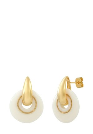 Boucles d'oreilles dorées avec un design sculptural, accentuées par un détail pointu et une base circulaire en résine blanche, agrémentées d'une petite anneau intérieur.