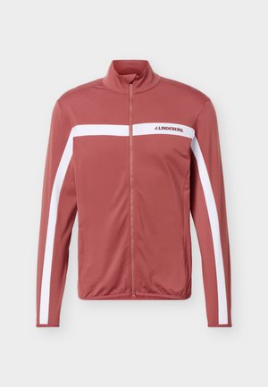 Rostrote Reißverschlussjacke mit weißen Streifen über der Brust und entlang der Ärmel, mit "J.LINDEBERG"-Logo auf der linken Brustseite.