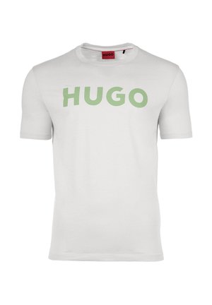 Weißes Baumwoll-T-Shirt mit einem großen grünen "HUGO"-Logo auf der Vorderseite. Rundhalsausschnitt und kurze Ärmel, glatte Textur.