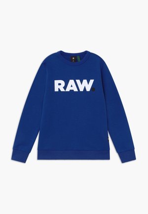 Sweat-shirt bleu à manches longues avec col rond, texte blanc en gras « RAW. » centré sur la poitrine, poignets et ourlet côtelés.