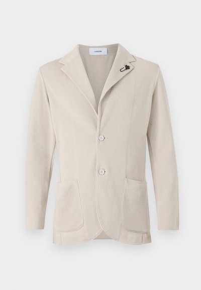 Beige knädd blazer med notch-lapel, två framfickor och rosa knappar. Har en liten svart detalj på kragen.