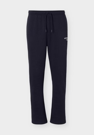 Granatowe, casualowe spodnie dresowe z elastycznym pasem i sznurkiem, lekko zwężane nogawki oraz białym logo na prawej udzie.