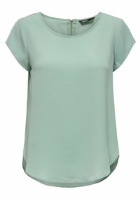 Haut court à manches courtes vert clair avec un col rond et une fermeture éclair au dos. Tissu texturé avec un ourlet légèrement arrondi.