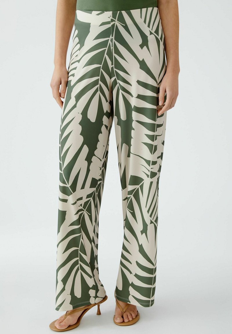 Grüne und beige gemusterte weite Hosen mit einem Blattdesign, aus glattem Stoff, mit einem elastischen Bund und einer lockeren Passform.