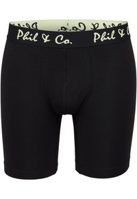 Boxer cortos de algodón negro con una cinturilla suave que presenta el texto "Phil & Co." en amarillo claro. Textura suave y diseño ajustado.