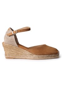 Smeđi suede wedge espadril s pletenim jute potplatom. Ankle traka s srebrnom kopčom, teksturirana tkanina na peti, dizajn s zaobljenim prstima.