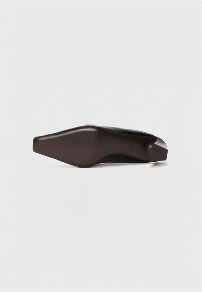 Brown high-heeled shoe with a pointed toe and a matte finish. The heel is block-shaped and has a smooth texture.
