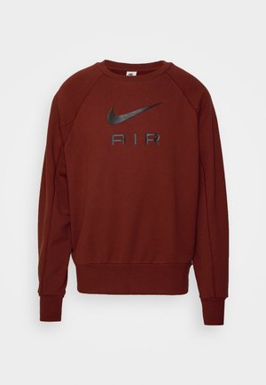 Nike sweatshirt in roestkleur, met een groot zwart logo "AIR" aan de voorkant, ribgebreide manchetten, ronde halslijn en raglanmouwen.