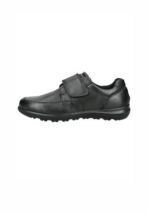 Schwarzer Lederschuh mit einem breiten, verstellbaren Klettverschluss und einer strukturierten Sohle, die für Komfort und einfaches Tragen designed ist.