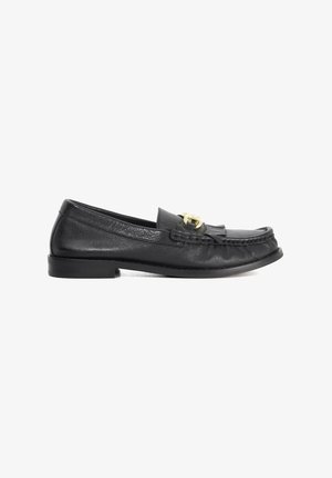 Black leather loafer with a rounded toe, decorative fringe, and a gold-tone buckle accent. Low-profile sole with slight heel.