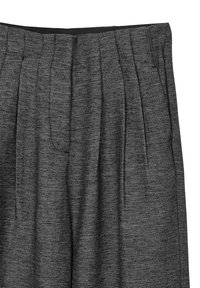 Pantaloni grigi a scacchi houndstooth con design plissettato, caratterizzati da una vita nera. Il tessuto testurizzato conferisce profondità all'aspetto.