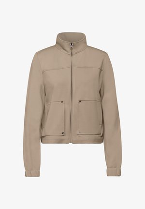 Giacca beige con zip e colletto alto, due tasche frontali e polsini aderenti. Realizzata in un tessuto liscio e strutturato. Design minimalista.