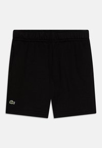 Czarne bawełniane szorty z elastycznym pasem, z małym zielono-białym logo na dolnej lewej stronie. Gładka tekstura, do kolan.