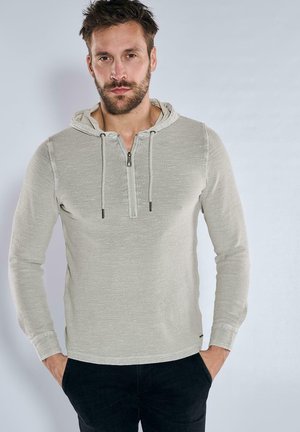 Light gray hoodie made of textured fabric, featuring a half-zip closure, drawstring hood, and long sleeves. Slim fit with side pockets.