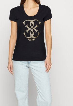 Musta istuva t-paita lyhyillä hihoilla, jossa on kultainen logo keskellä. Kangas näyttää sileältä, ja siinä on pyöreä pääntie.