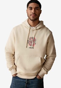 Beżowa bluza z kapturem wykonana z miękkiego materiału, z kolorową florystyczną grafiką i sznurkami, posiadająca przednią kieszeń oraz ściągacze na rękawach.