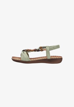 Light green flat sandal with braided straps, elastic back, and brown cushioned sole, shown from the side on a white background.