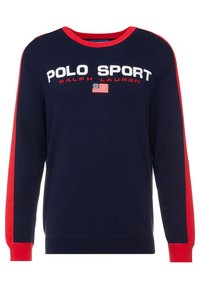 Navy sweatshirt with red sleeve accents, featuring white text “POLO SPORT” and an American flag logo. Ribbed neckline and cuffs.