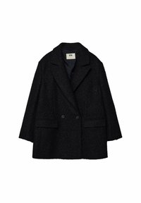 Abrigo negro de textura con un frente de doble botonadura, solapas con muesca, dos bolsillos frontales y un ajuste holgado. Etiqueta visible en el interior.
