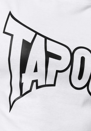 White cotton t-shirt featuring bold black lettering spelling "TAP" in a dynamic, stylized font. Smooth texture, simple design.