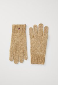Guantes de punto beige con puño acanalado, que presentan un pequeño logotipo en contraste. Textura suave y ajuste estándar para ofrecer calidez y comodidad.