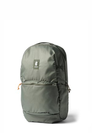 Gray-green backpack with front zippered pocket, side loops, and a small white logo patch on the upper front panel.