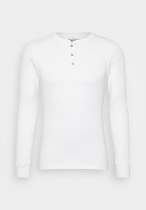 Witte lange mouwen henley shirt van ribstof, met een ronde halslijn, een drie-knopjes sluiting en aansluitende manchetten.