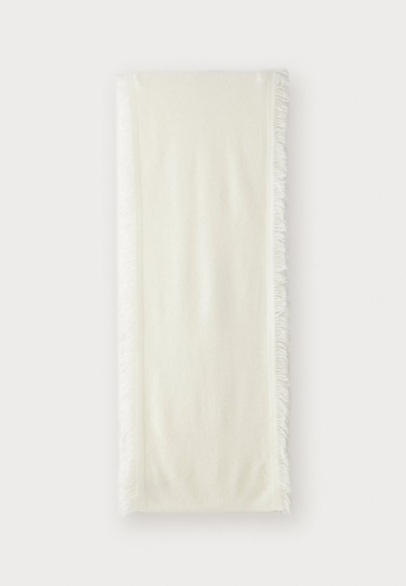 Jeté en textile blanc avec des bords frangés, fabriqué en matériau doux, de forme rectangulaire, texture lisse et légère brillance.