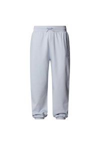 Ljust blå mjukisbyxor i mjuk bomull, med dragsko i midjan, elastiska muddband och en liten logotyp på vänster ben.