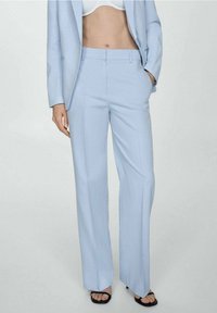 Light blue tailored trousers made of smooth fabric, featuring a straight cut, front pockets, and a waistband with belt loops.