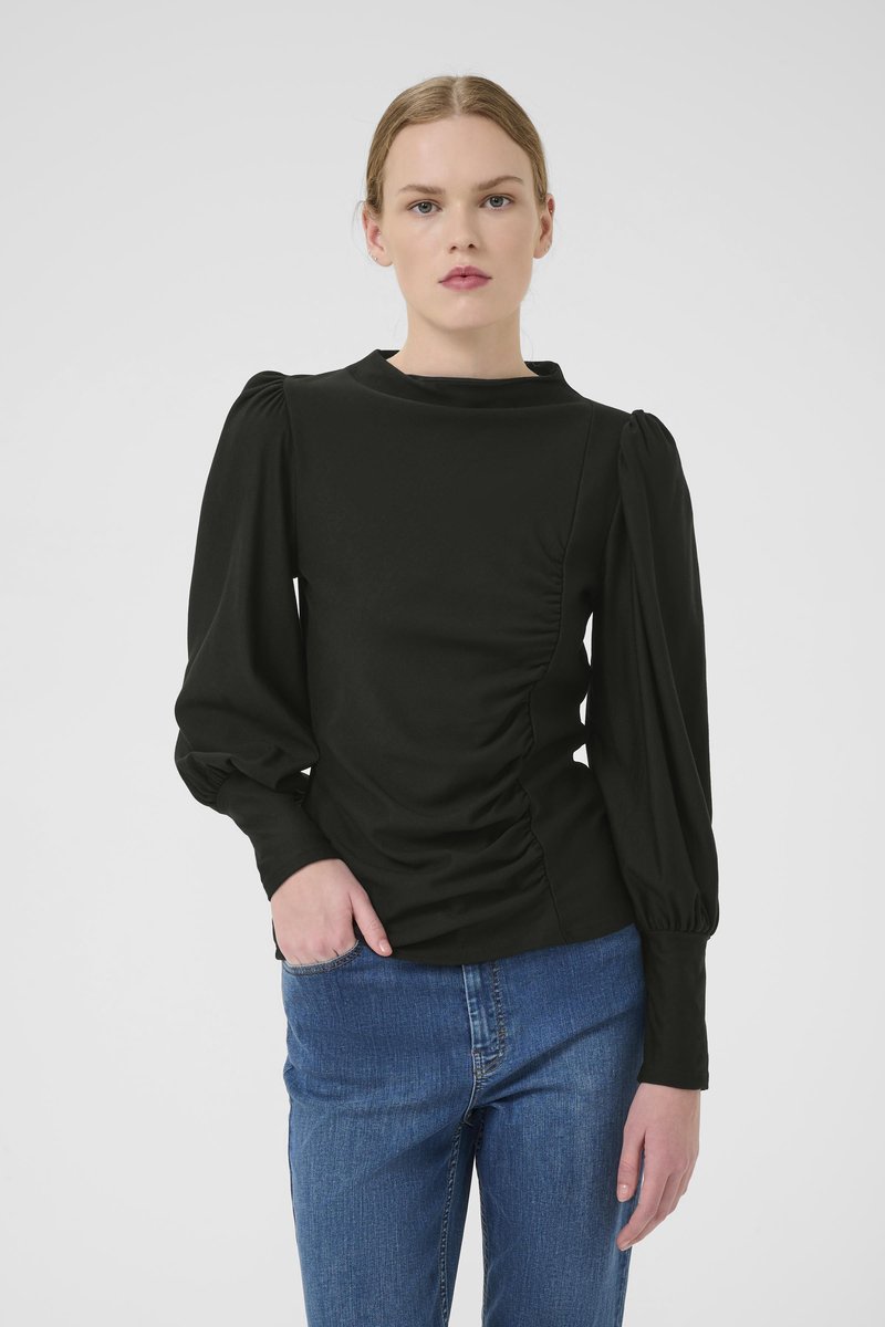 Black long-sleeve top with a high neckline, ruched side detail, and puffed sleeves, paired with blue denim jeans. Smooth texture.