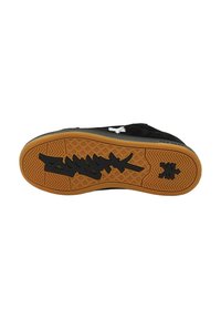 Svart sneakersåle med gummibunn, med teksturerte gripe mønstre og en fremtredende svart graffiti-stil logo.