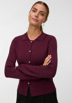 Bordeauxkleurige cardigan met een kraag, lange mouwen en een knoopsluiting aan de voorkant. Opvallende zilveren knopen voegen detail toe aan de zachte, gebreide textuur.
