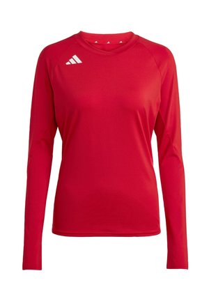 Pitkähiha, punainen urheilu paita, joka on valmistettu sileästä ja joustavasta kankaasta. Siinä on pyöreä kaula-auko ja vasemmassa olkapäässä valkoinen kolmen raidan logo.