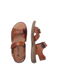 Sandales en cuir marron avec deux sangles réglables, côtés ouverts et semelle intérieure rembourrée. Semelle texturée pour l'adhérence et le confort.