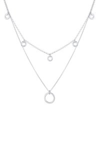 Collana a strati in argento con più anelli interconnessi sulla catena, di diverse dimensioni. Superficie liscia, design minimalista e finitura lucida.